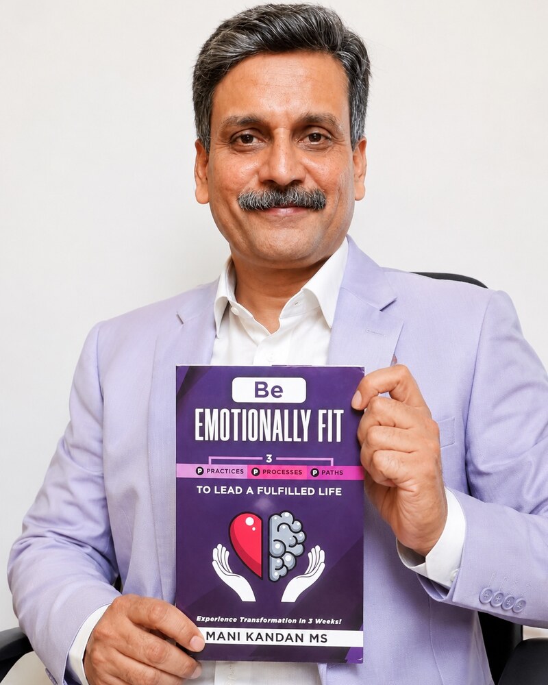 Mani Kandan MS, published author of Be Emotionally Fit, holding his paperback