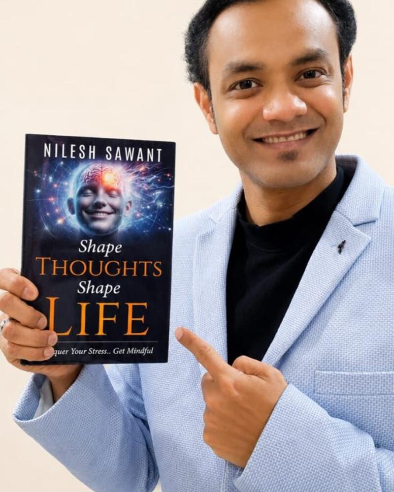 Nilesh Sawant, published author of Shape Thoughts Shape Life, holding his paperback
